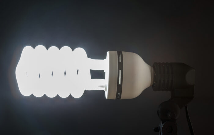 Several illuminated household LED bulbs against a dark background