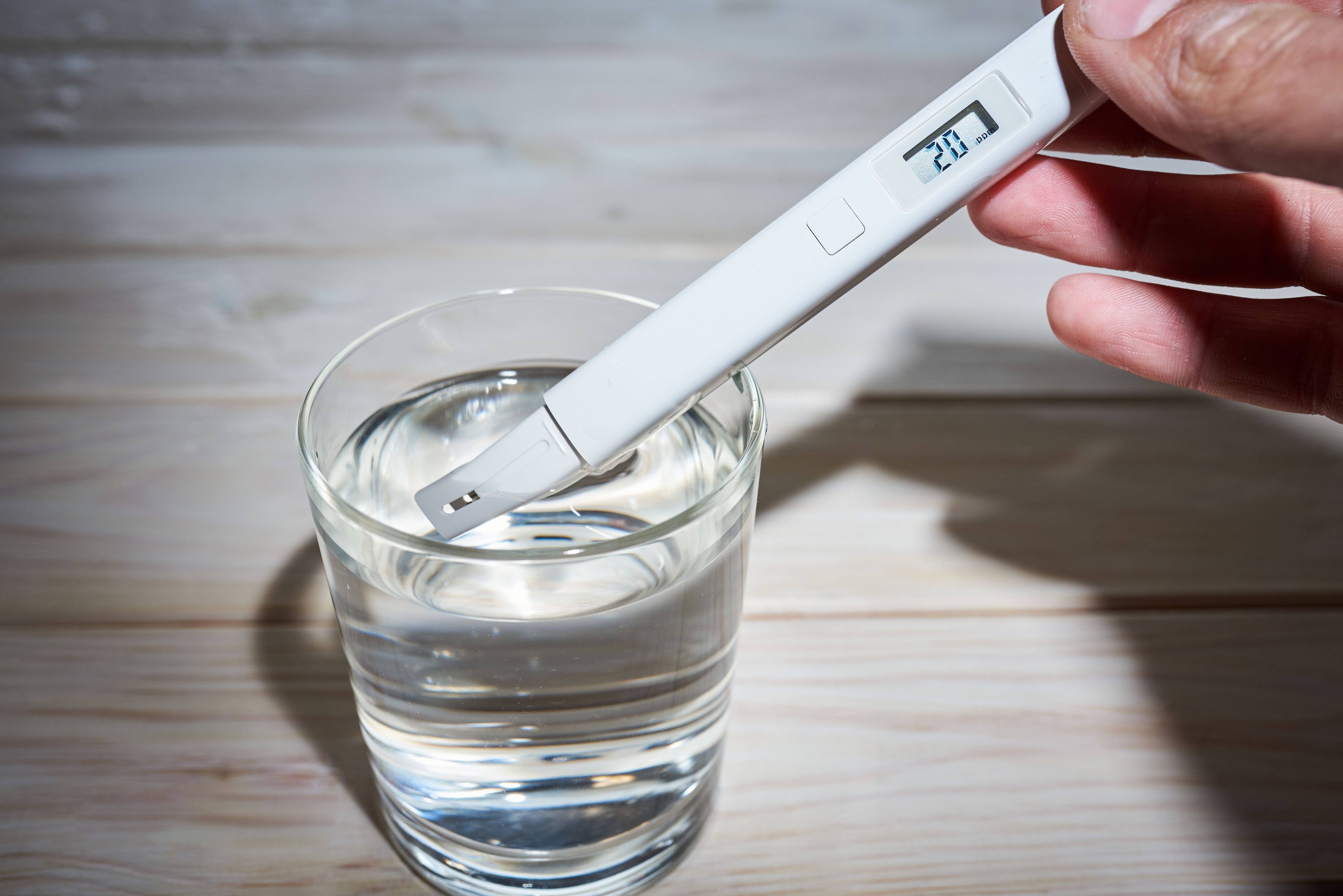 Electric water tester measuring EC, TDS, and salt content in water.