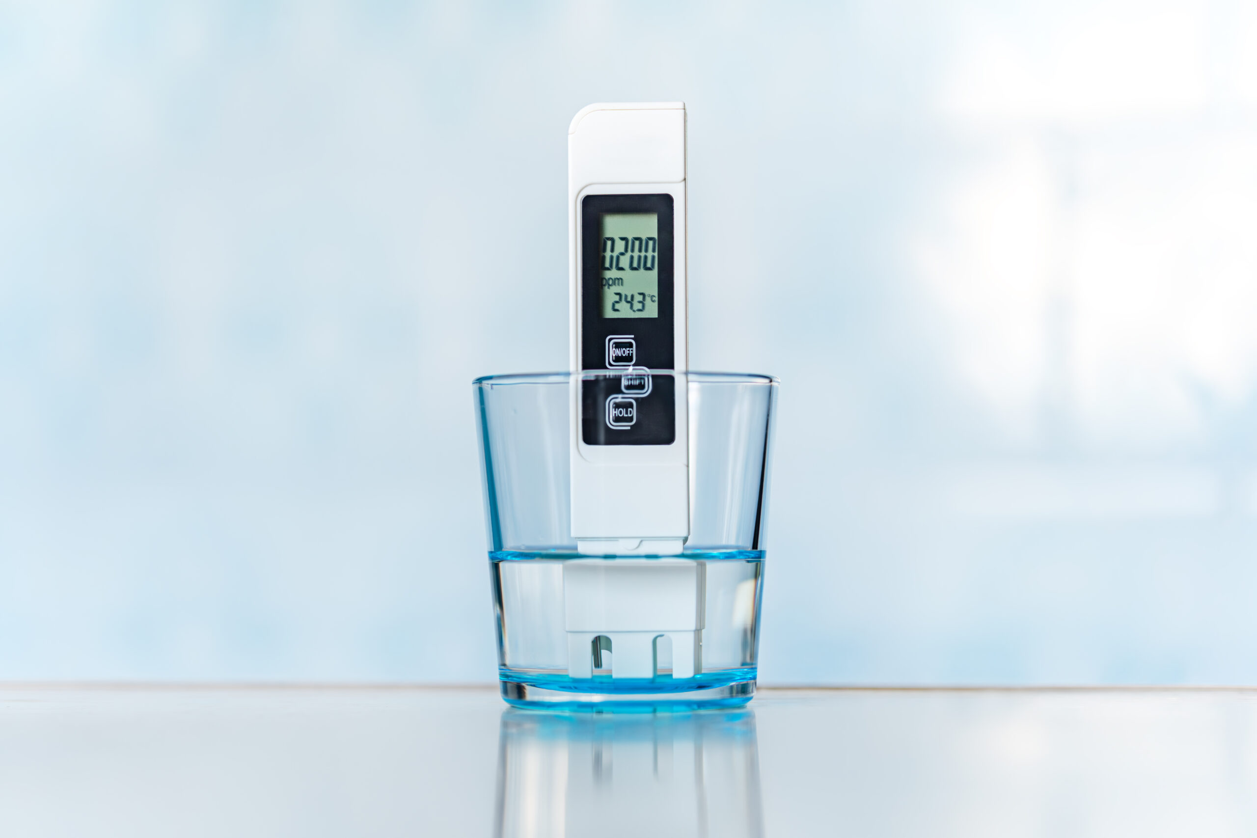 Digital water-quality meter testing a solution sample