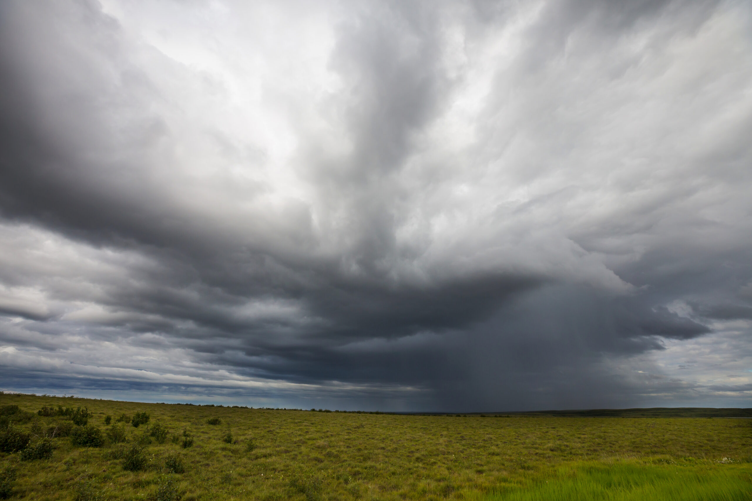 Rain clouds moving across a high mountain landscape