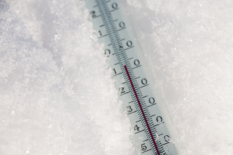 Thermometer on snow shows low temperatures