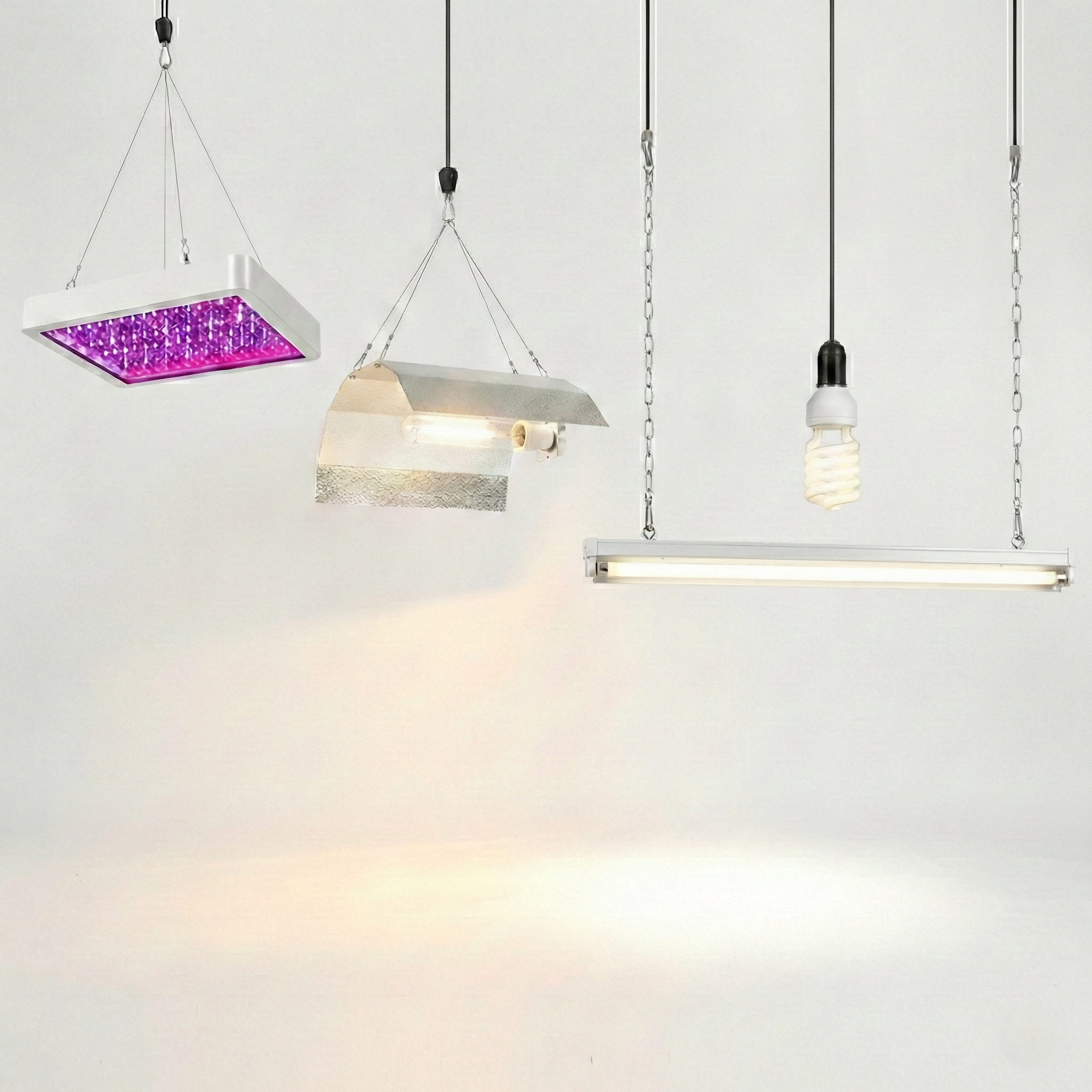 grow-light-types-led-hid-fluorescent-cfl Different grow light types hang side by side, including an LED panel, reflector fixture, fluorescent bar, and CFL bulb